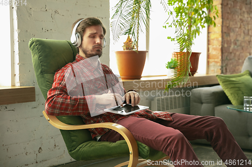 Image of Caucasian man staying at home during quarantine because of coronavirus spreading