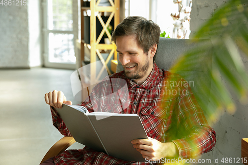 Image of Caucasian man staying at home during quarantine because of coronavirus spreading