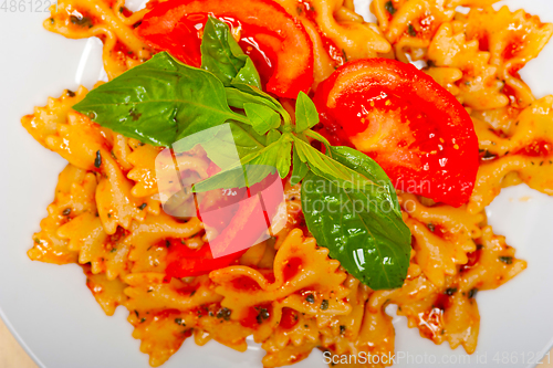 Image of Italian pasta farfalle butterfly bow-tie and tomato sauce