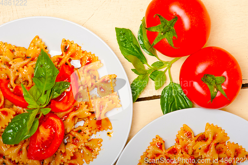 Image of Italian pasta farfalle butterfly bow-tie and tomato sauce