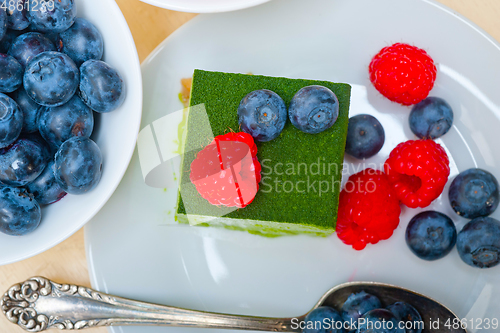 Image of green tea matcha mousse cake with berries