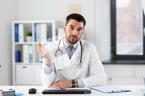Image of male doctor having video conference at hospital