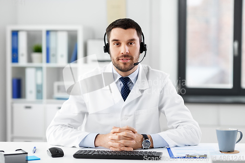 Image of happy male doctor with headset at hospital