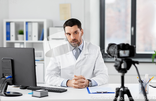 Image of male doctor with recording video blog at hospital