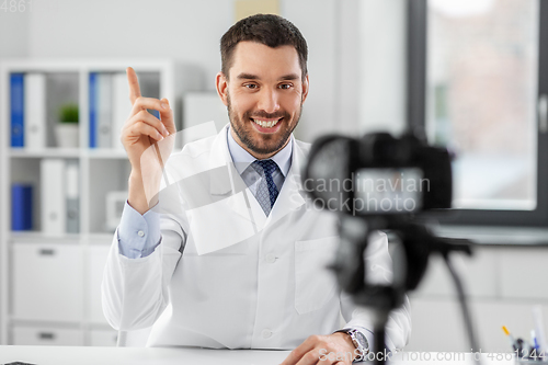 Image of male doctor recording video blog at hospital