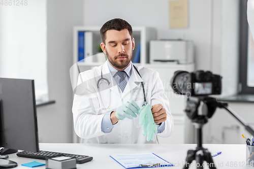 Image of male doctor with gloves recording video blog