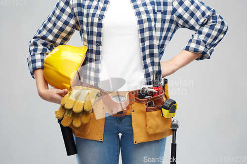 Image of woman or builder with helmet and working tools