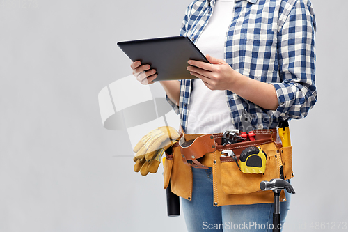 Image of woman or builder with tablet pc and working tools