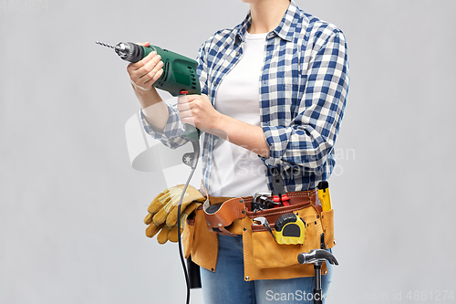 Image of woman or builder with drill and work tools