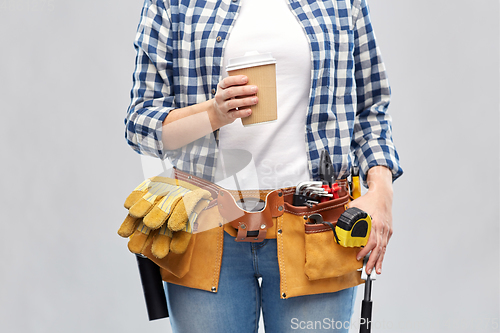 Image of woman with takeaway coffee cup and working tools