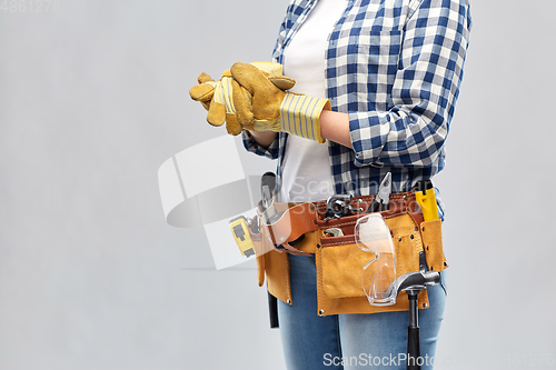 Image of woman or builder with gloves and working tools