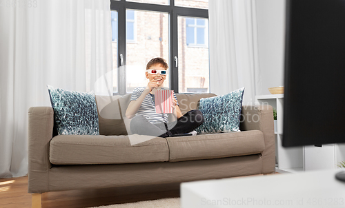 Image of boy in 3d movie glasses and watching tv at home