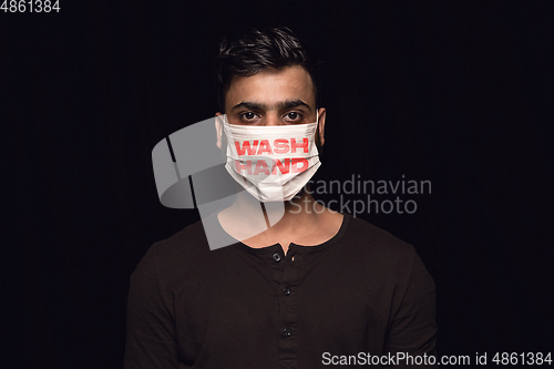 Image of Man in protective mask with words WASH HANDS, coronavirus prevention, protection concept