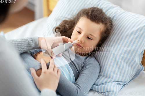 Image of mother with nasal spray treats sick daughter