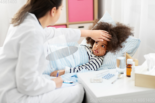 Image of doctor with clipboard and sick girl in bed at home