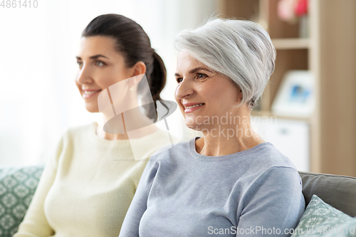 Image of portrait of old mother and adult daughter at home