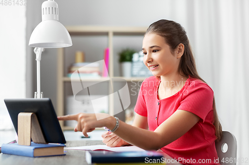 Image of student girl with tablet pc learning at home