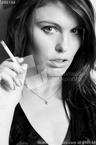 Image of young beautiful girl smoking