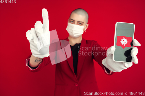 Image of Young woman with freaky appearance on red background wearing face mask