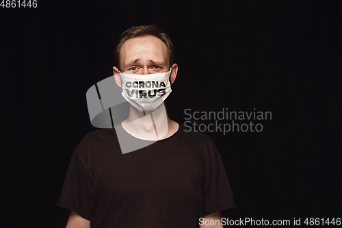 Image of Man in protective mask with word CORONAVIRUS, coronavirus prevention, protection concept