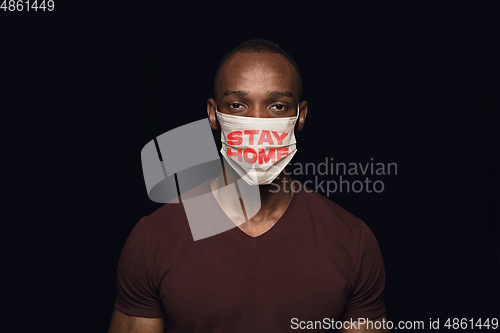 Image of Man in protective mask with words STAY HOME, coronavirus prevention, protection concept