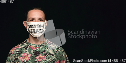 Image of Man in protective mask with words WASH HANDS, coronavirus prevention, protection concept