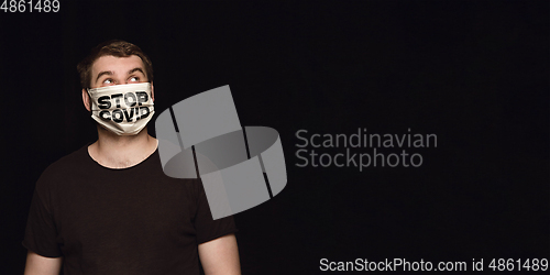 Image of Man in protective mask with words STOP COVID, coronavirus prevention, protection concept, flyer