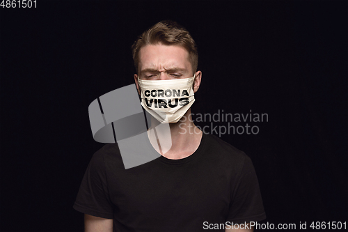 Image of Man in protective mask with word CORONAVIRUS, coronavirus prevention, protection concept