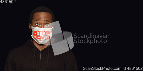 Image of Man in protective mask with words STOP COVID, coronavirus prevention, protection concept, flyer