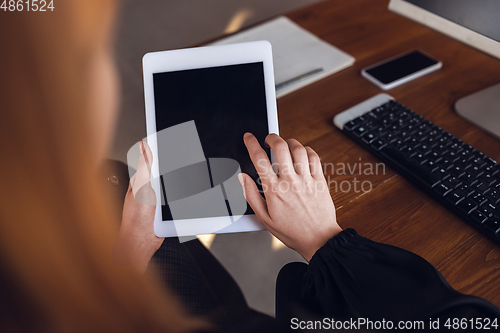 Image of Caucasian young woman in business attire working in office