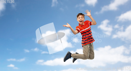 Image of happy smiling young boy jumping in air over sky