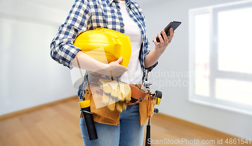 Image of woman or builder with phone and working tools