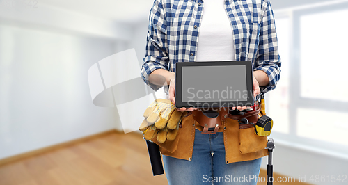 Image of woman builder with working tools showing tablet pc