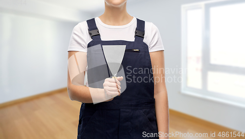 Image of close up of female builder with putty knife