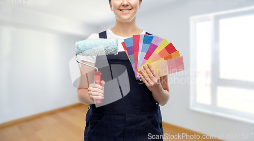 Image of close up of painter with roller and color charts