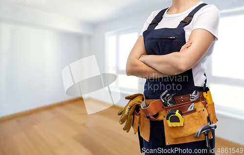 Image of woman or builder with working tools on belt