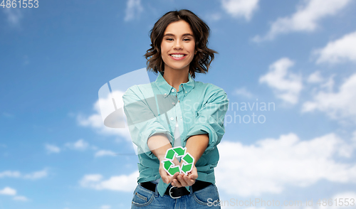 Image of smiling young woman holding green recycling sign