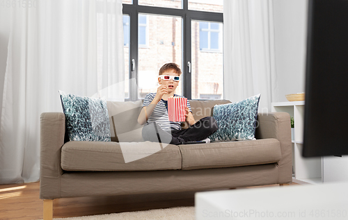 Image of boy in 3d movie glasses and watching tv at home