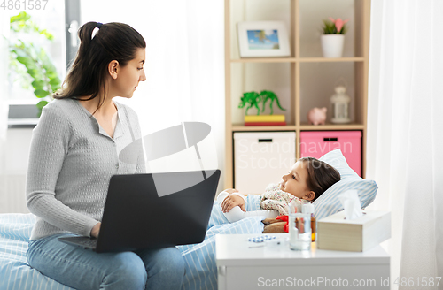 Image of ill daughter and mother with laptop at home