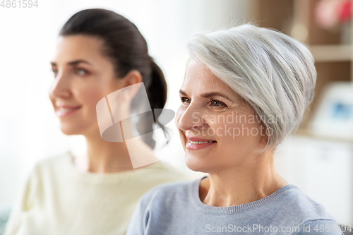 Image of portrait of old mother and adult daughter at home