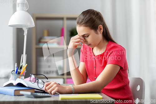 Image of tired teenage student girl with glasses at home