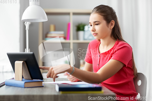 Image of student girl with tablet pc learning at home