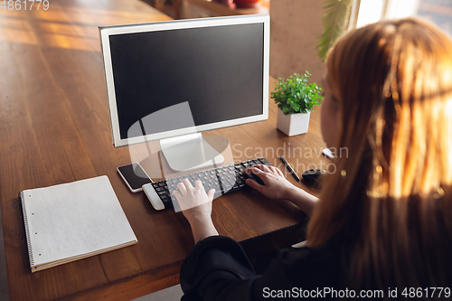 Image of Caucasian young woman in business attire working in office