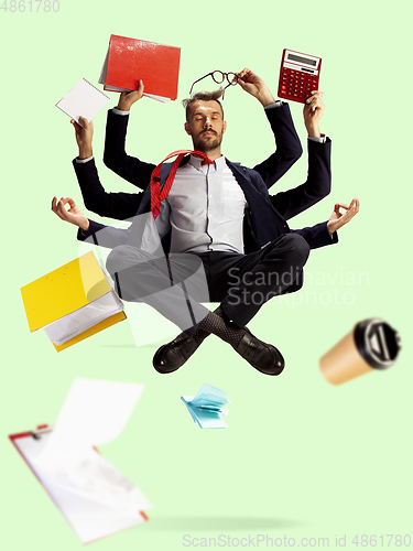 Image of Young caucasian businessman, manager who manages everything, a lot of things and deals