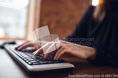 Image of Caucasian young woman in business attire working in office