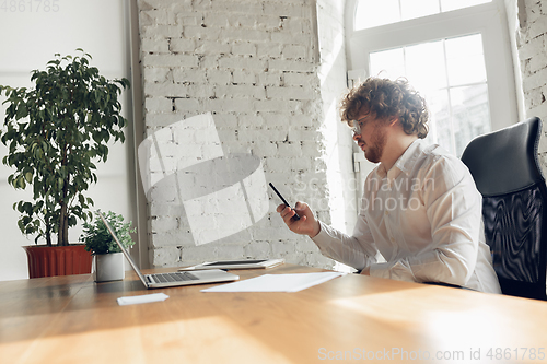 Image of Caucasian young man in business attire working in office, job, online studying