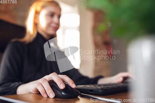 Image of Caucasian young woman in business attire working in office