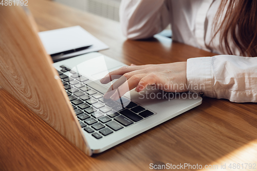 Image of Caucasian young woman in business attire working in office