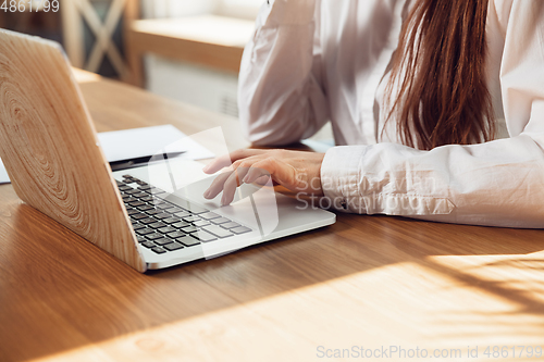 Image of Caucasian young woman in business attire working in office