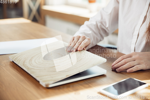 Image of Caucasian young woman in business attire working in office